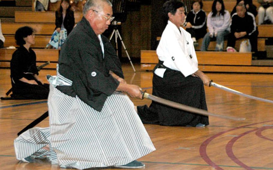 Iaidoka (practitioners of Iaido) demonstrate one of the many techniques used in Iaido, a martial art focused on the drawing of the sword, at the Camp Fuji Martial Arts Expo on Saturday.