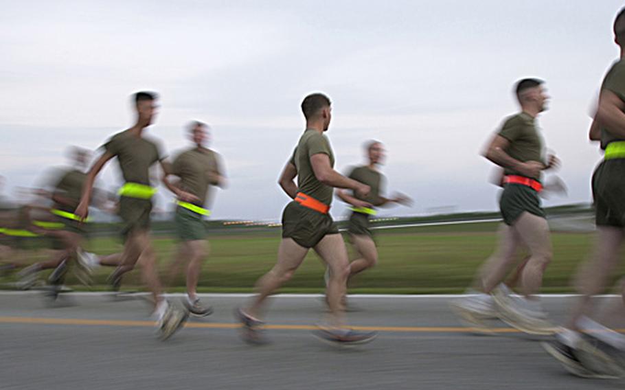 Marines race to catch up with the rest of the 3rd Marine Division 3-mile formation run to celebrate the Marine Corps’ birthday on Camp Hansen Tuesday.