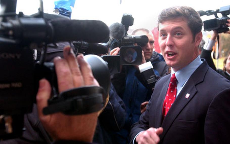 Democratic Congressional candidate in Pennsylvania and Iraq War veteran Patrick Murphy is surrounded by the news media after voting Tuesday in Bristol, Pa.