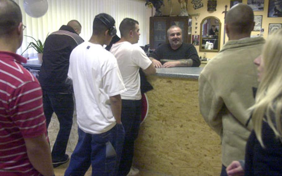 Soldiers line up at Jörg’s Tattoo and Piercing Studio on Monday afternoon in Baumholder, Germany. With the recent return from Iraq of about 4,000 soldiers, business has increased steadily in Baumholder, and German police have seen little trouble.