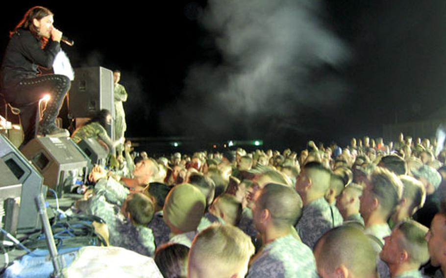 Brent Smith, singer for the rock band Shinedown, performs for troops at Camp Taqaddum, Iraq, during a concert on Saturday night.