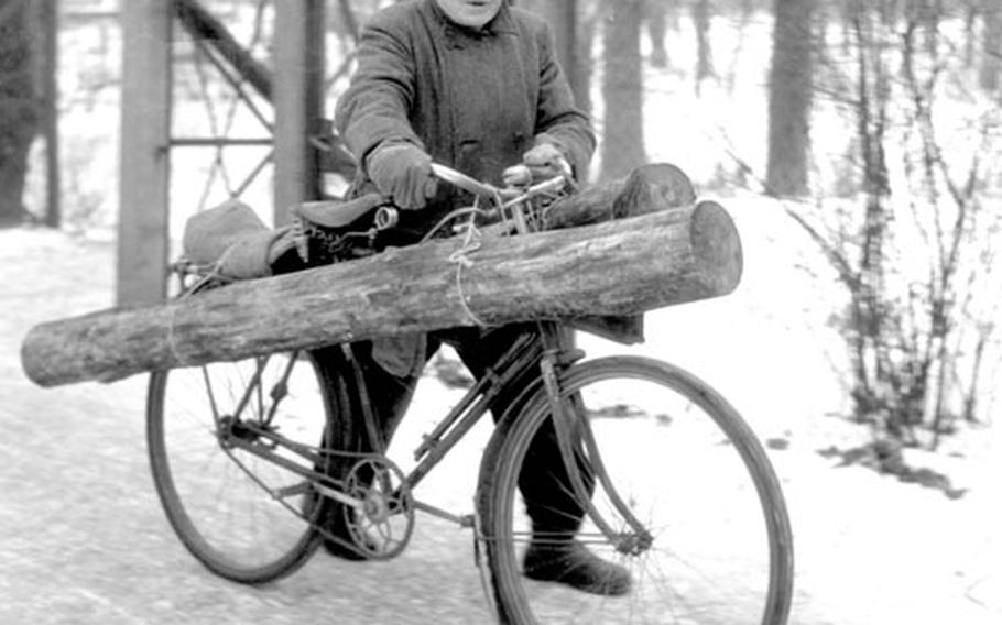 A Berliner uses his bike to carry home a piece of firewood to supplement the meager coal ratiion.