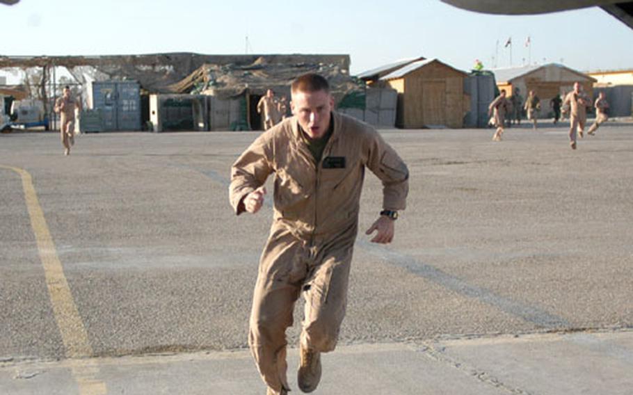 First Lt. Andrew Hamilton and his mates scramble for their helicopter to respond to an emergency evacuation in Anbar province, Iraq. Hamilton belongs to the HMM-364 Purple Foxes casualty evacuation unit at Camp Taqaddum.
