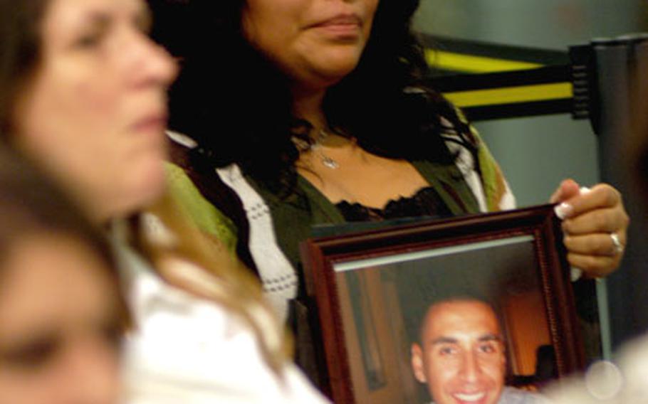 At a naturalization ceremony in Frankfurt, Germany on Tuesday, Salina Jimenez clutches a photograph of her husband, Sgt. David Jimenez Almazan, who was killed by a roadside bomb in Iraq on Aug. 27. Almazan, born in Mexico, was posthumously granted U.S. citizenship. Jimenez accepted her husband’s naturalization certificate.