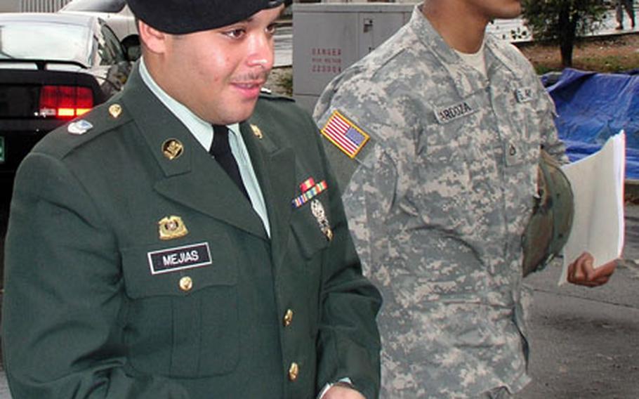 At Camp Humphreys, South Korea, on Wednesday, Army Pvt. Mitchel Mejias Jr., 20, left, of New Hampshire, is escorted in handcuffs to a vehicle that was to take him to the Camp Humphreys jail. Mejias faces nine months in prison and a bad-conduct discharge after pleading guilty Wednesday to an array of charges that included assaulting and being disrespectful to officers and sergeants, and being drunk and disorderly.