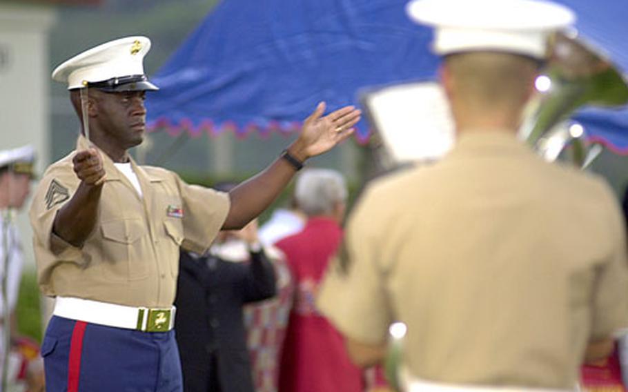 Staff Sgt. Michael July, senior enlisted conductor for the III Marine Expeditionary Force Band, directs the band during a change-of-command ceremony at Camp Foster in September.