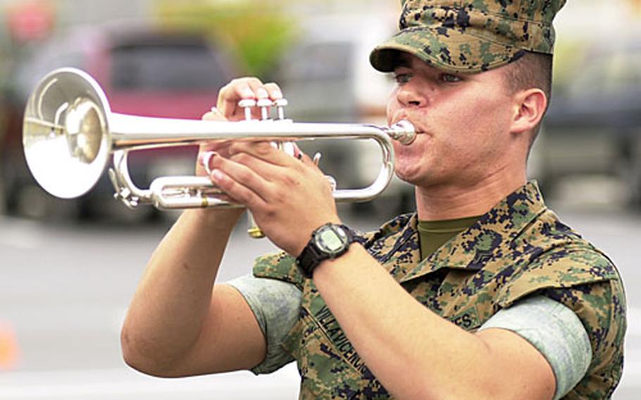 Cpl. Carlo A. Villavicencio and the rest of III Marine Expeditionary Force Band practice drill and music on Camp Foster on Nov. 2 in preparation for a performance at Marching Festival 2006 in Tokyo.