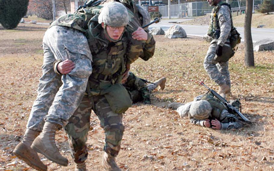 Trainers wear down soldiers with carries and low crawls to better simulate combat fatigue during the Soldier First Responder course at Camp Casey on Friday.