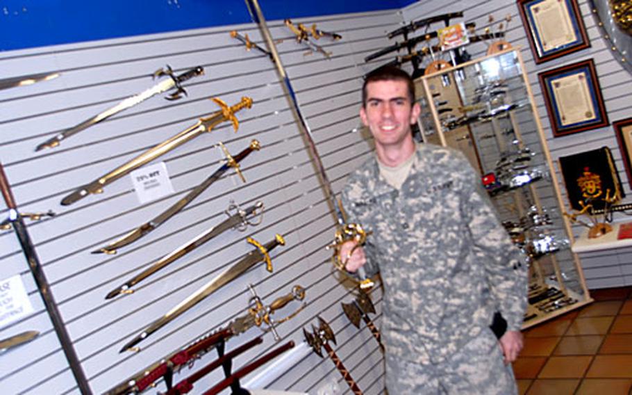 Pfc. Daniel Waller, 19, a Schweinfurt-based 101st Military Intelligence Battalion soldier from Savannah, Ga., shops at Vilseck on Monday for a cutlass to add to his collection of 20 swords that he keeps in the U.S.