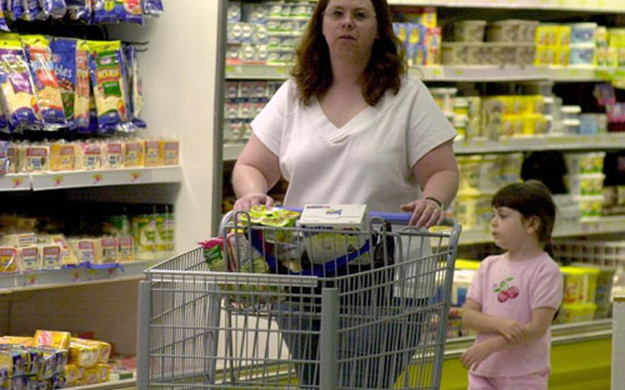 Jill Cheatham shops with her daughter, Jenna, at the Vilseck commissary in July. The Defense Commissary Agency recently received high marks in a U.S. European Command quality-of-life survey.