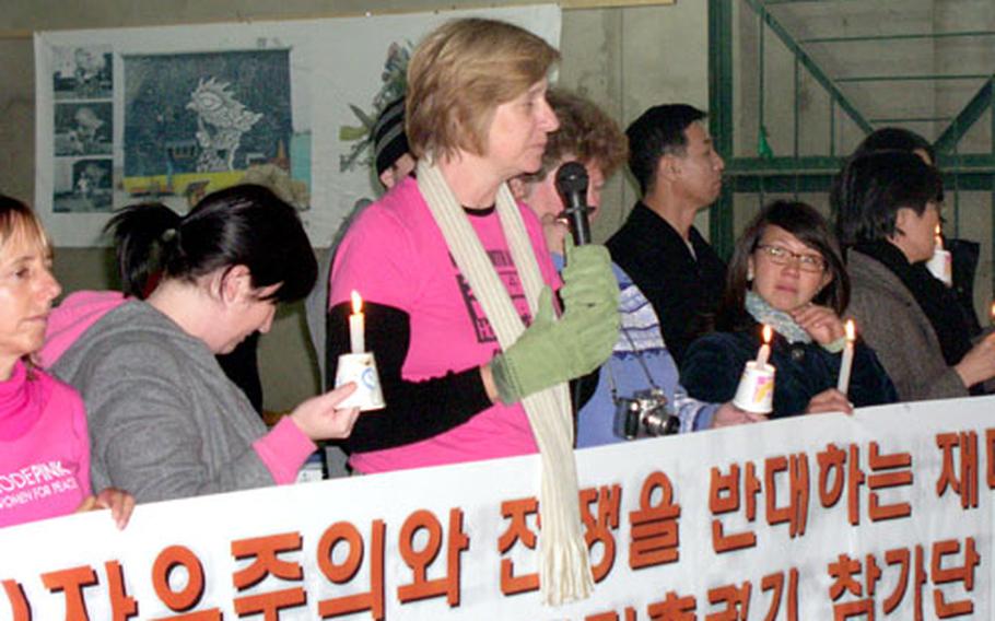 Antiwar activist Cindy Sheehan, center, speaks to about 75 area residents of a village near Camp Humphreys in Pyeongtaek, South Korea, Monday night. Sheehan and about 20 other activists visiting from the United States spoke against the project during a candlelight vigil in Daechu-ri village.
