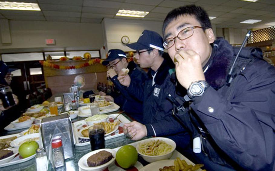 Korean National Police guards eat lunch at the Three Kingdom’s Inn Dining Facility on Monday during a visit to Yongsan Garrison.