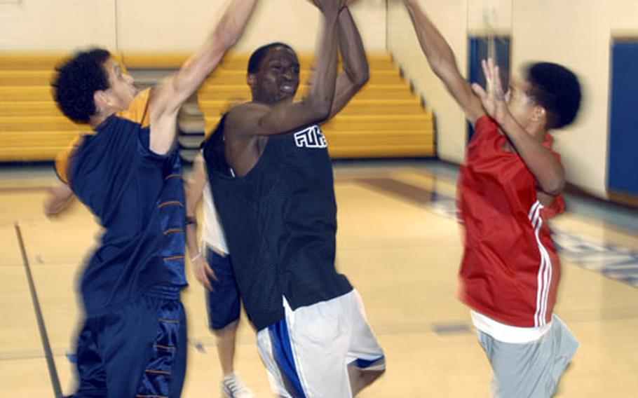 The Lakenheath Lancers finished last season with just one win in the bruising Division I conference. Junior guard Eddie Alford, center, seen here in a practice session last week with sophomore Aaron Miles, left, and freshman Taiyo Robertson, is expected to lead the team to bigger things while also helping the younger guys develop their game.