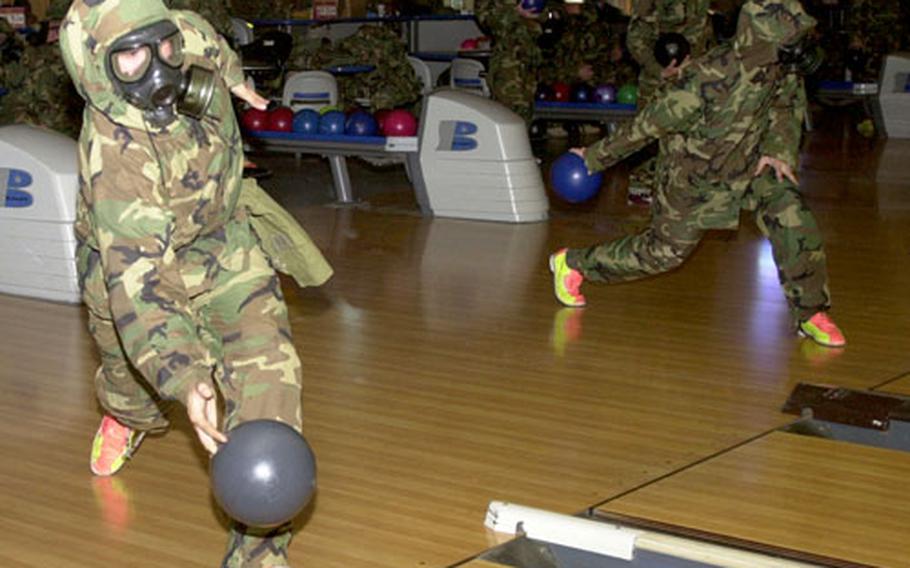 Soldiers fire bowling balls down the lane Tuesday during the 1st Battalion, 38th Field Artillery’s Chemical, Biological, Radiological, Nuclear training at the Camp Casey Bowling Center. The 2nd Infantry Division unit is required to complete four hours of annual training so soldiers rotated in and out of classes between games.