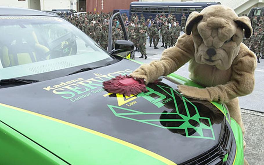 Big Dog, the 18th Logistic Readiness Squadron mascot (portrayed here by Air Force Staff Sgt. Bobby Humphrey), buffs the hood of the Kadena mock race car called ZZ13.