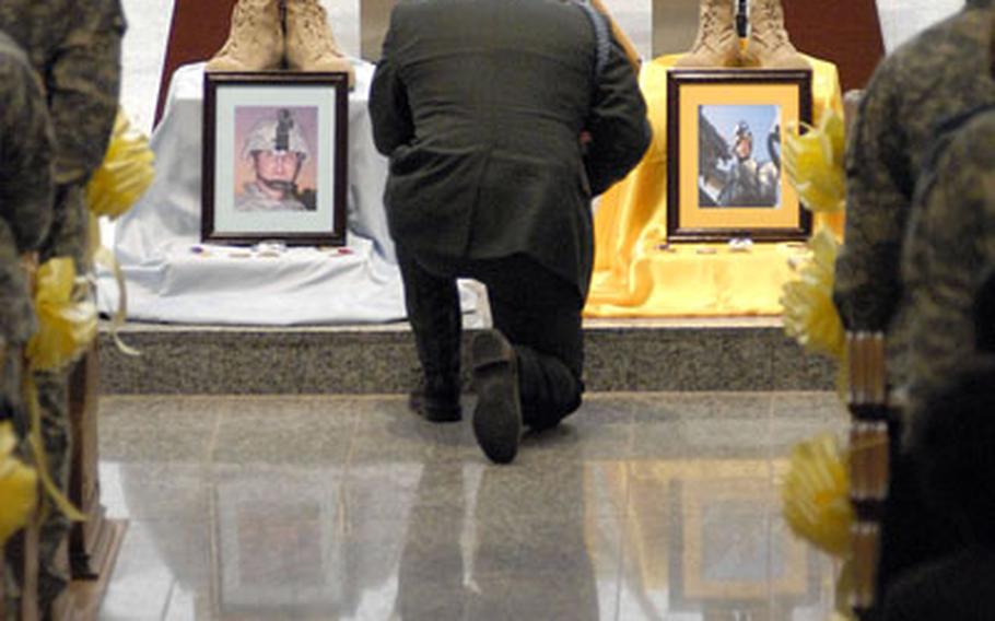 Lt. Col. James Danna, III, a battalion commander, pauses in memory of Maj. David Taylor and Spc. Carl Eason during a memorial ceremony held in Baumholder, Germany, on Wednesday.