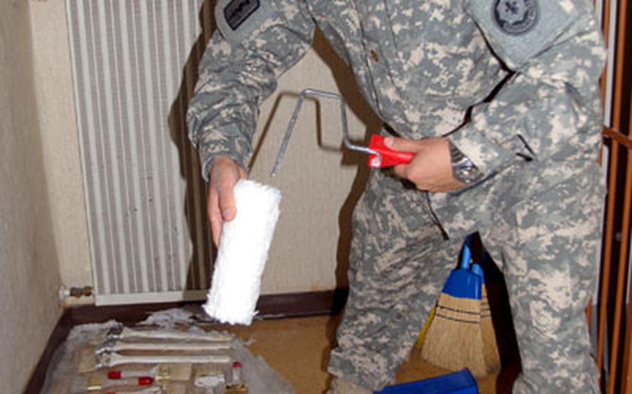 Chaplain (Maj.) Samuel Lee, of 2nd Cavalry (Stryker) Regiment, prepares paint rollers to be used to turn an old building into a new coffeehouse and drop-in center for soldiers in Vilseck, Germany.