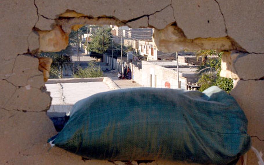 Through a hole on the roof of Combat Outpost Steel, U.S. soldiers can keep an eye on the Ramadi suburb of Ta’meem, where roadside bombs and sniper attacks have been regular occurrences.