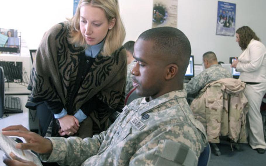 Leslie Stancoven, the contractor installation manager for the Baumholder Army Career and Alumni Program, helps Cpl. Alphonso Milton II from the 1st Battalion, 35th Armor Regiment put together a resume Nov. 20th. About 400 soldiers are planning on separating after recently returning from a deployment to Iraq. Milton is hoping to get a job in law enforcement. The ACAP provides a two-day job assistance workshop and a resume writing workshop to assist soldiers for up to six months after separating. Retirees receive ACAP assistance for life.