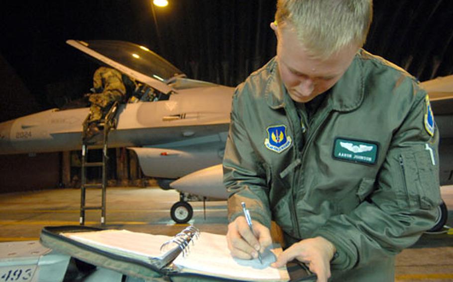 First Lt. Aaron Johnson, of the 555th Fighter Squadron, signs off the checklist after completing a preflight inspection for an alert aircraft supporting the North Atlantic Treaty Organization Summit on Wednesday in Riga, Latvia. The 555th Fighter Squadron was on alert to keep the skies safe.
