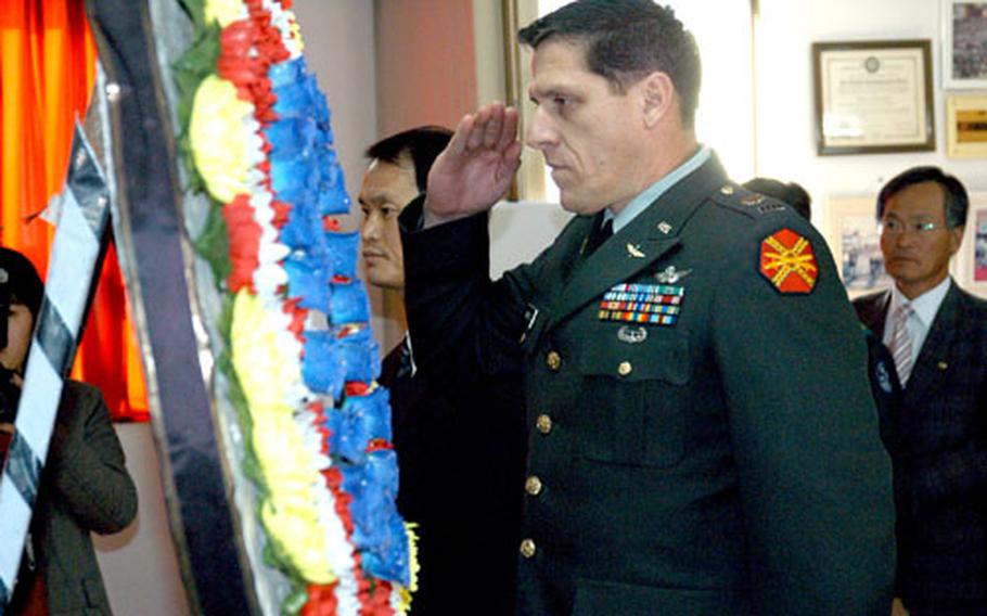 Army Chief Warrant Officer Brian E. Parrotte salutes as U.S. military officials join South Korean residents of Namhae Island during the 61st annual memorial service for a World War II American bomber crew in Namhae, South Korea, on Wednesday. Namhae resident Kim Duk-hyun established the services in 1945.