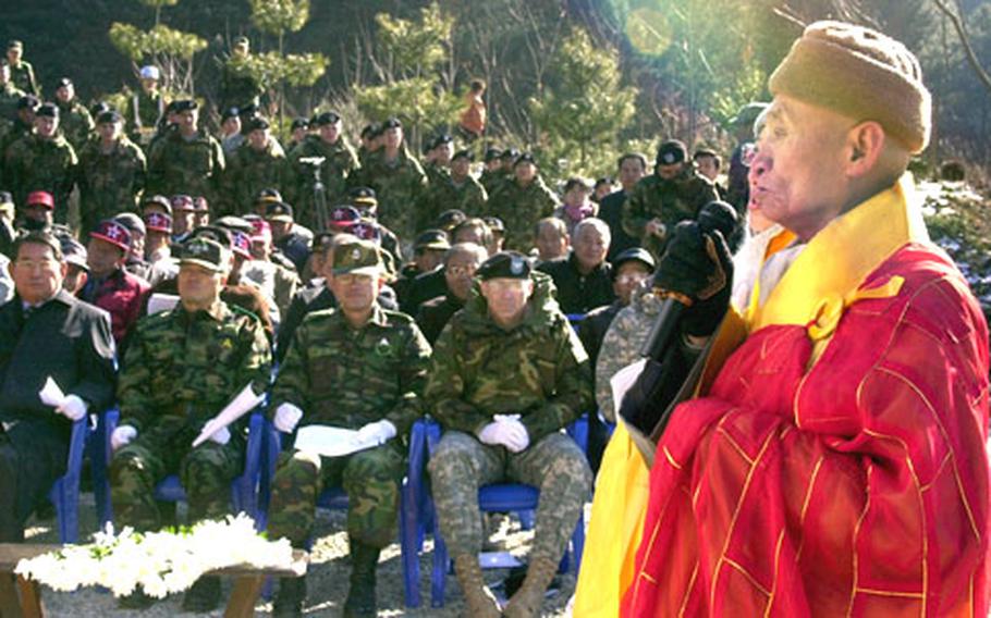 Buddhist chief monk Lee Doil says a blessing before the unveiling of a memorial to the 2nd Infantry Division's 1st Battalion, 72nd Armor Regiment, in Chun-an-ri Monday. During the Battle of Kapyong in 1951, the unit fought off a North Korean and Chinese offensive while completely surrounded. Doil helped the the unit and the United Nations allies during the fight while living in a temple not far from the memorial. He still lives there today.