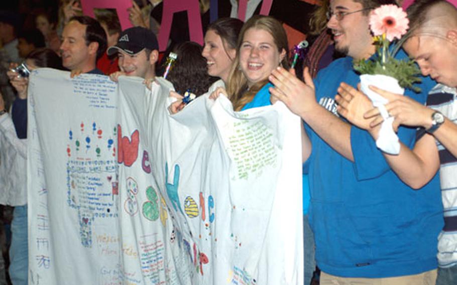 Can you spell "happy"? Some 300 family members and friends of V Corps Headquarters and Headquarters Company waited two hours in the gym on Patton Barracks for their returning soldiers, who'd spent not quite a year in Iraq, then shouted with glee when they finally appeared.
