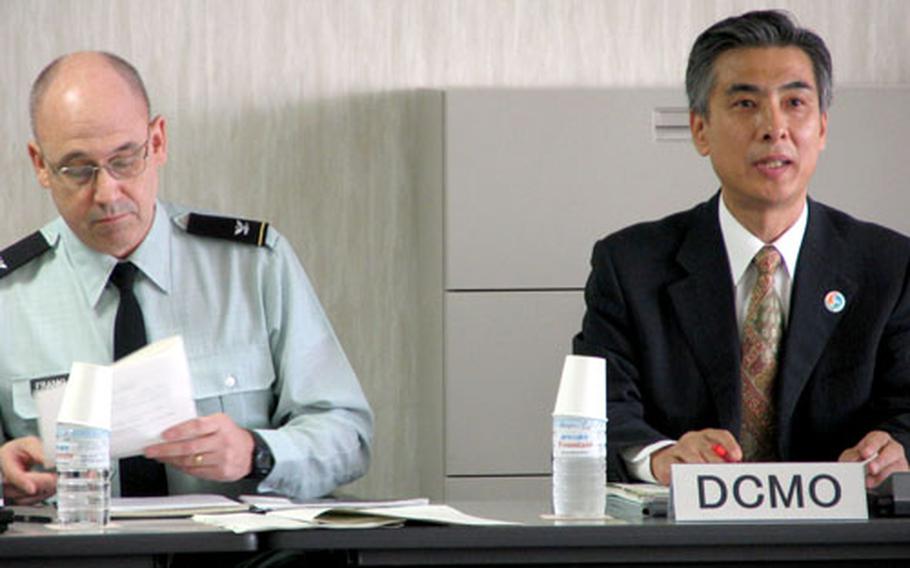 U.S. Army Col. Mark R. Franklin, chief of the Okinawa Area Field Office of U.S. Forces Japan, and Mitsuho Kayashima, Tokyo's director for Crisis Management in Okinawa, co-chair Tuesday's crisis management meeting. The committee was formed in response to confusion at the scene of the crash of a Marine helicopter in the city of Ginowan in August 2004.