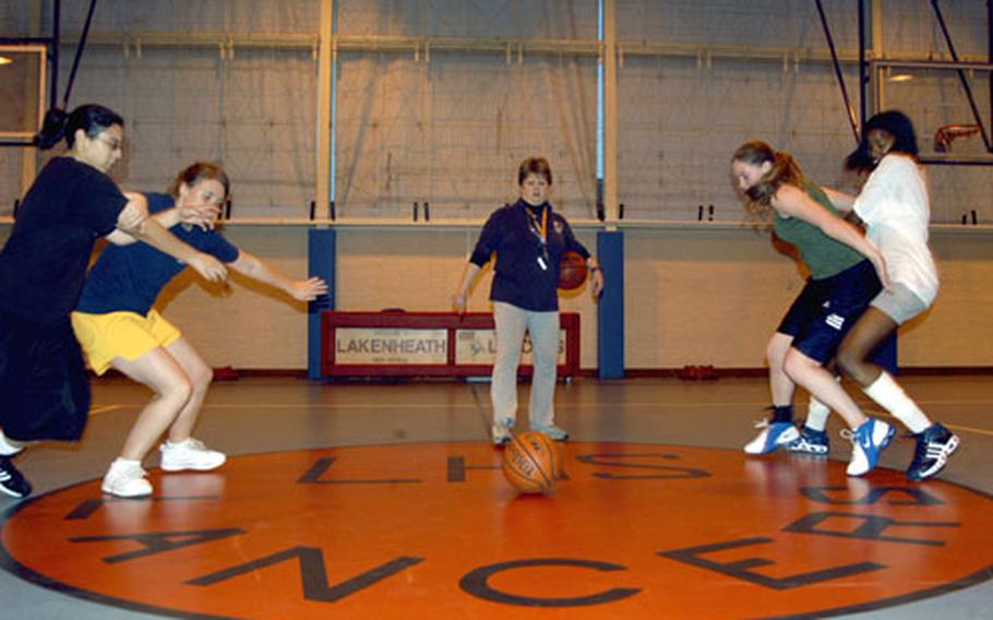 Alconbury girls basketball coach Janis Ready watches as four players practice a boxing-out drill. The Lady Lancers have a handful of returning experienced players.
