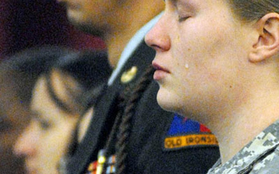 A soldier morns during the firing of the volley at the end of a memorial service for Staff Sgt. Michael Shank and Spc. Jeffrey Roberson Thursday at Daenner Kaserne.