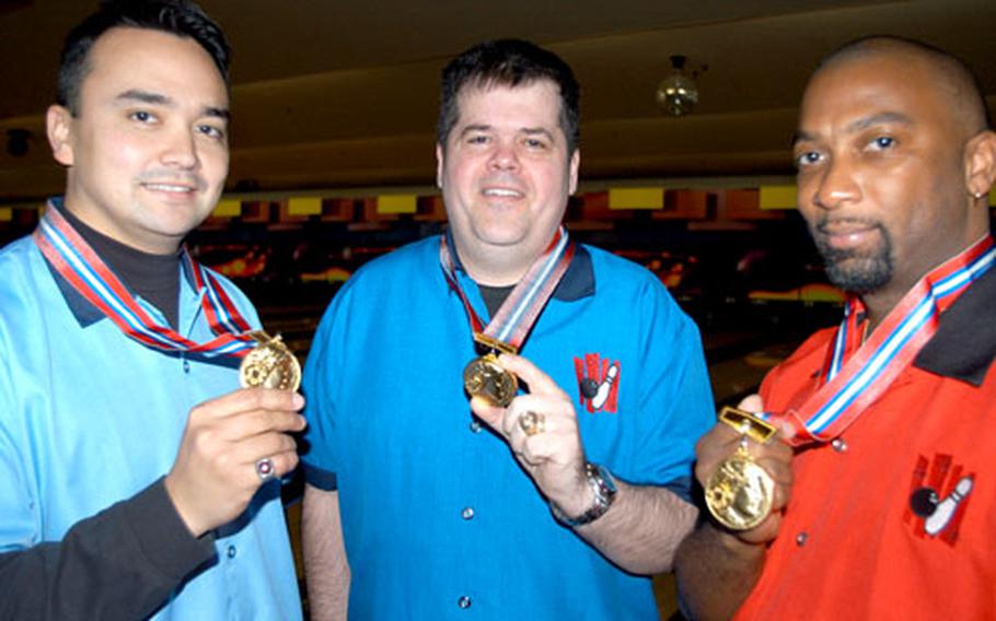 While wearing their championship bowling shirts, Misawa bowlers, from left, Staff Sgt. Shawn Matter, Senior Master Sgt. Joe Carney and Kevin Radford hold up the medals they won for their victory last month at the largest annual bowling tournament in Aomori Prefecture.