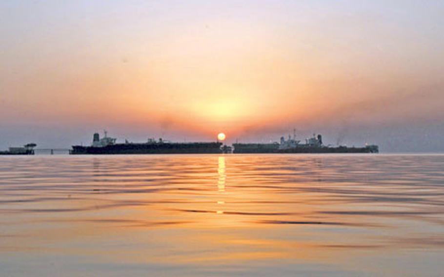 The sun sets behind the Basra oil terminal in the northern Persian Gulf in October. The off-shore facility pumps about 1.5 million barrels of crude oil a day into commercial oil tankers, making it the mainstay of the Iraqi economy.