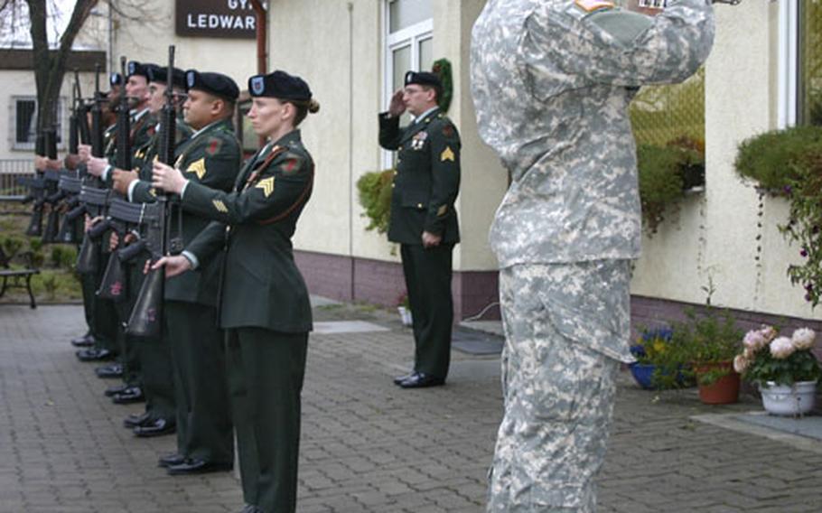 Spc. Adam Keele, a bugler with the 1st Armored Division Band, plays Taps near the honor guard during the memorial ceremony Tuesday honoring Spc. Ross Andrew McGinnis and Spc. Jordan William Hess, who were killed in Iraq.