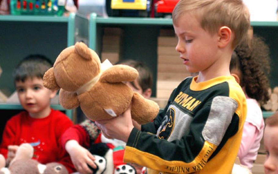 Wiesbaden preschooler Mark Jones bids his bear adieu Wednesday as part of a stuffed animal drive for needy Afghan and Iraqi children. The effort, which concludes Monday, already has led to at least 78 donated furry friends.