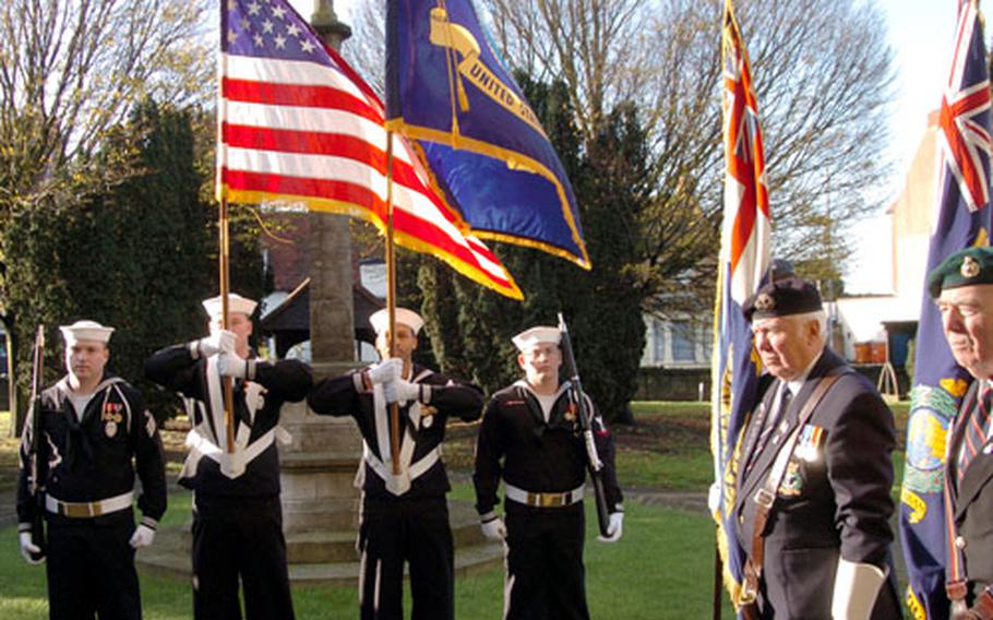 Members of the color guard from Commander, U.S. Naval Activities, United Kingdom, from left, Master-at-Arms Seaman Zack Gamble, Master-at-Arms 2nd Class Brian Booker and Master-at-Arms 3rd Class Robert Rubio display the American standard at the Pearl Harbor Day ceremony with the British Royal Naval Association at Southend-on-Sea recently.