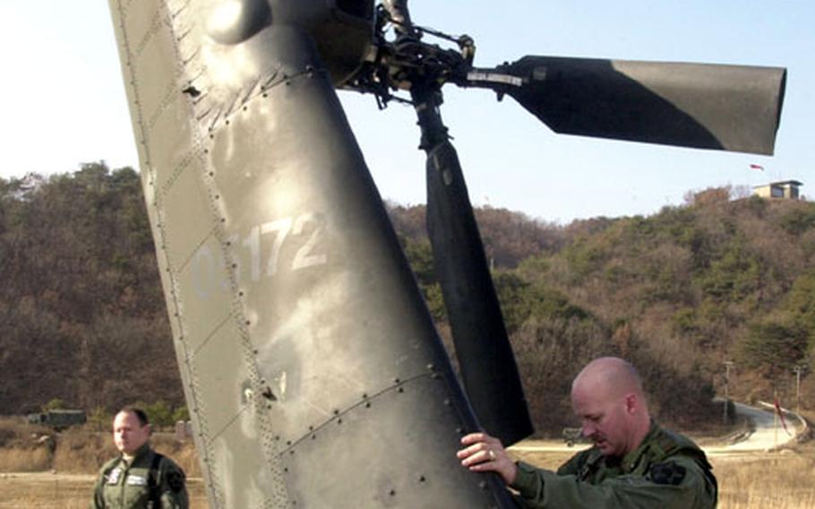 Chief Warrant Officer 3 Lee Major of the 2nd Infantry Division's 1st Aviation Battalion, 2nd Aviation Regiment checks out his AH-64 Apache helicopter for a live fire exercise Thursday at Rodriguez Range. Apache crews coordinated fire with ground elements from the 4th Battalion, 7th Cavalry.