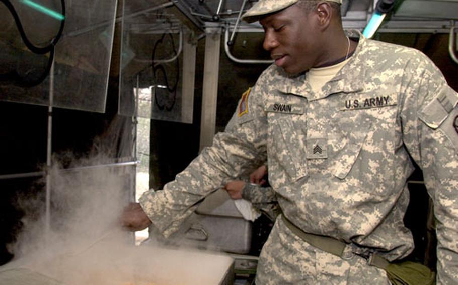 Sgt. Shedrick Swain mixes chicken thalk-bo-kum during the 501st Sustainment Brigade’s evaluation for the Connelly Award. The brigade is one of four units competing Armywide in the field food preparation category.