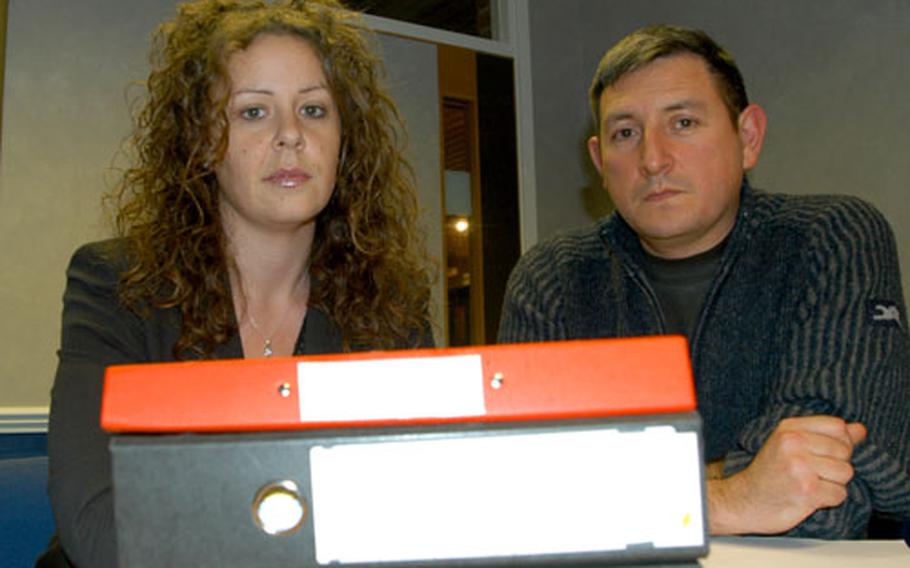 Attorney Sharon Allison and U.S. Air Force Tech Sgt. Brian Garcia sit behind a stack of files connected to Garcia’s claim against the U.S. Air Force for medical malpractice. The Air Force settled the claim with Garcia, but did not admit negligence.