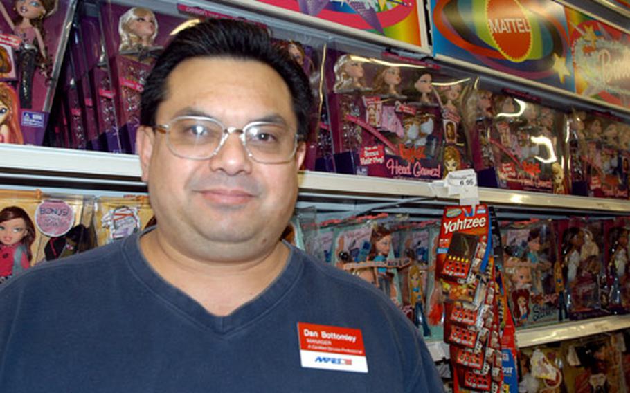 RAF Mildenhall BX manager Dan Bottomley says the popular Bratz dolls, behind him on the shelves, are selling well for the holidays.