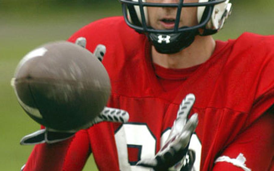 Lakenheath Lancers receiver Carl Snapp zeroes in on a pass during drills in August.