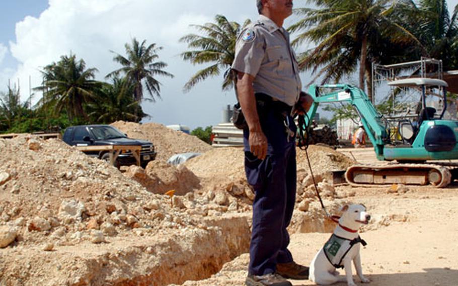 U.S. Department of Agriculture Wildlife Services dog handler Anthony Manibusan and dog Sawyer, at the groundbreaking ceremony for the new Working Dog Facility at Andersen Air Force Base, Guam.