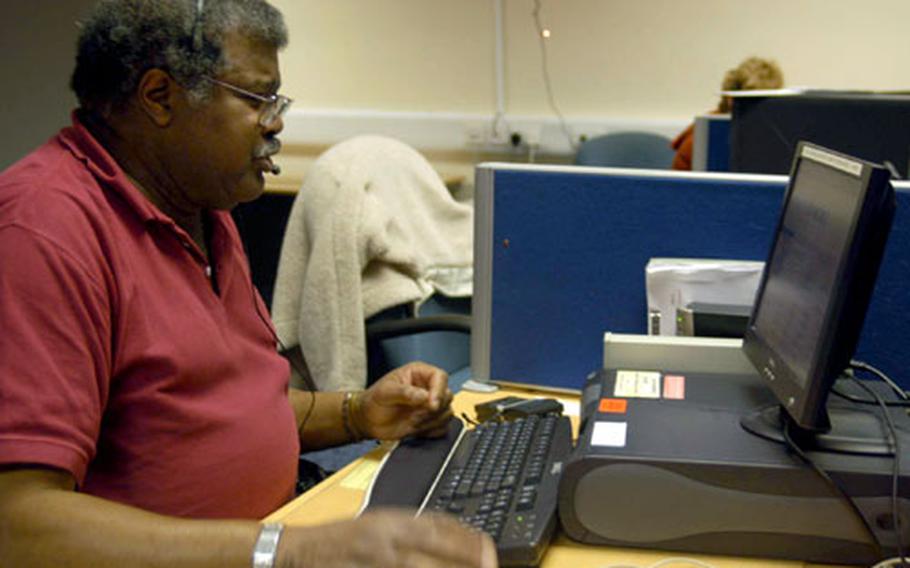 RAF Mildenhall switchboard supervisor Theadric Hannah helps out answering phones Friday after releasing most of his staff for the holiday weekend. Switchboard operations are being consolidation through U.S. Air Forces in Europe, meaning operators such as Hannah will soon be looking for new jobs.