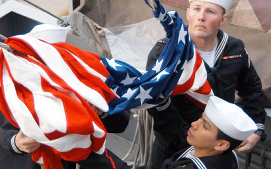 Petty Officer 2nd Class Efran Torres, Seaman Shawn Canfield and Seaman Apprentice Daniel Sullivan (hidden) raised Capt. Guy David Johnson’s flag aboard the USS Kitty Hawk Wednesday, 41 years to the day and his navigator, Lt. Cmdr. Lee Edward Nordahl, catapulted off the carrier’s flight deck and disappeared over North Vietnam.