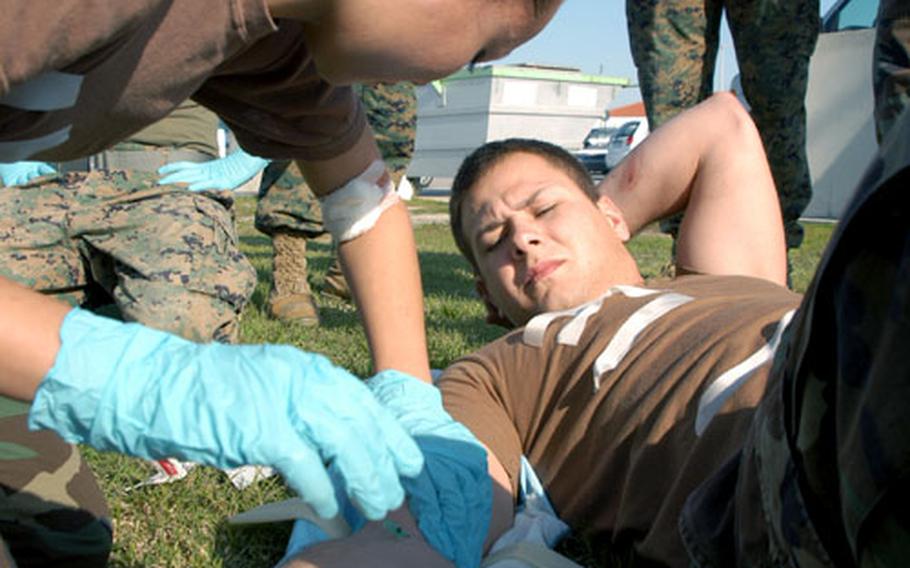 Petty Officer 3rd Class Theressa Jenson, a participant in the combat Life Saver Course, administers an IV to Seaman Apprentice Joshua Duran at Naval Station Rota, Spain. Seventy-three sailors and Marines took part in the three-day course administered by six volunteer Army reservists from the 7th Army Reserve Command, Medical Support Unit from Heidelberg, Germany.