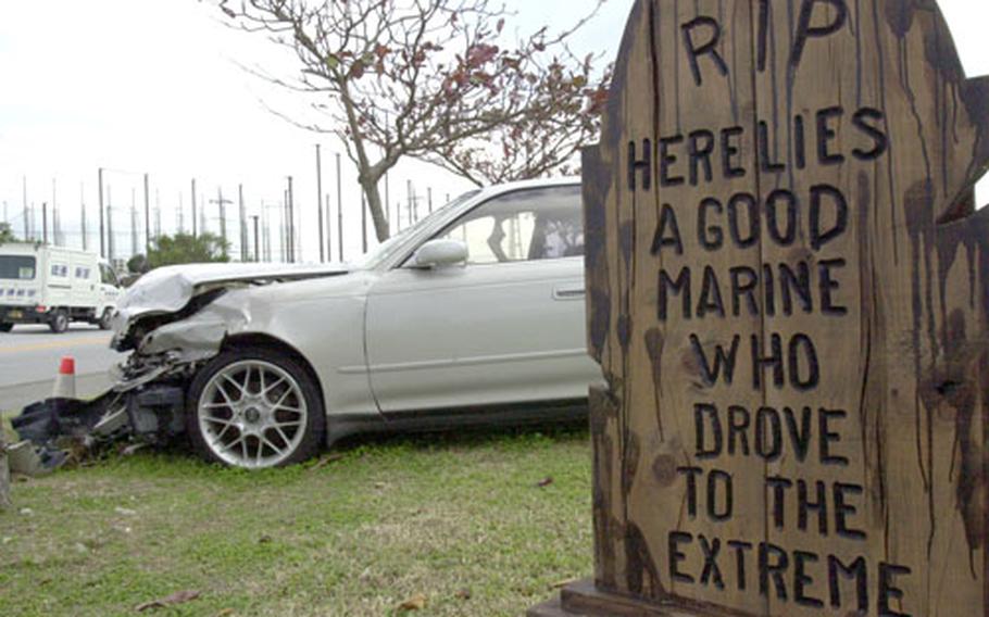 This wrecked car at the Camp Kinser Towers' gate is one of the educational portions of the 3D campaign.