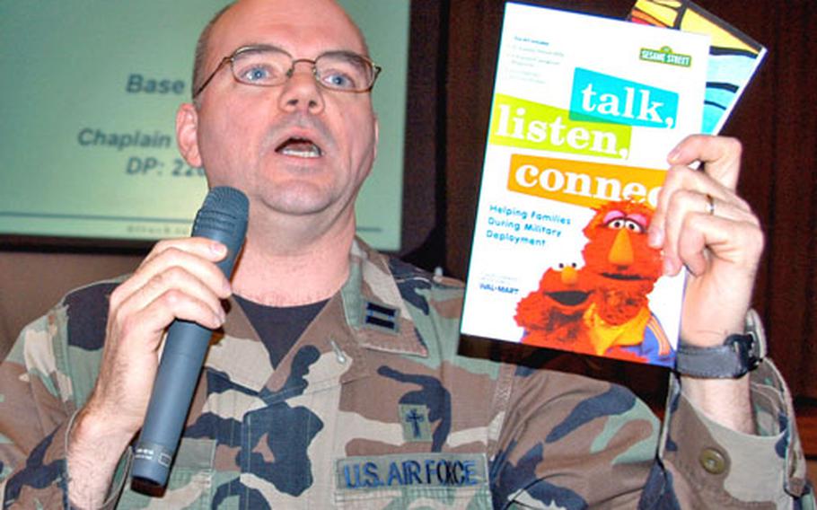 Capt. John Sackett, a base chaplain at Misawa Air Base, Japan, holds up a Sesame Street video available at the chapel intended to help kids cope with deployment. Sackett spoke Thursday night at a deployment briefing for airmen and spouses from the 35th Maintenance Group.