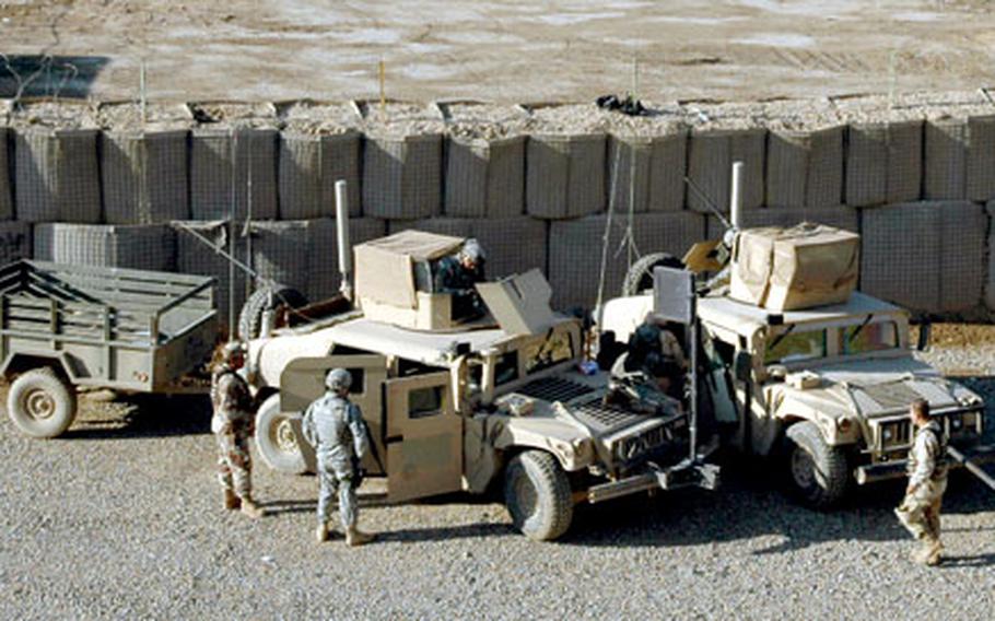 A convoy from the U.S. Military Transition Team prepares to roll out from its tiny base at the Iraqi Army’s 9th Division headquarters, Al-Rasheed Army Base, near Baghdad.
