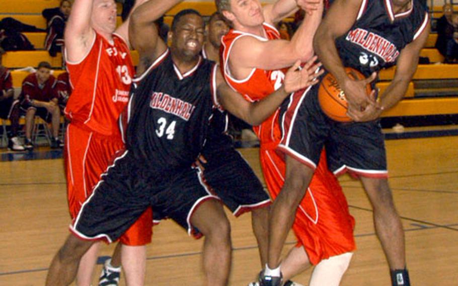Mildenhall’s Horace Johnson, right, pulls down a rebound during the Dave Allen Basketball Tournament at RAF Lakenheath. The tourney saw teams from RAFs Mildenhall and Lakenheath battling British semi-pro teams.
