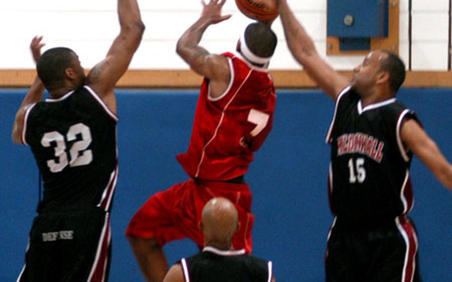 Lawrence Summers, a point guard for Kings Lynn, slips past a trio of Mildenhall players for a layup and two of his 60 points during the championship game.