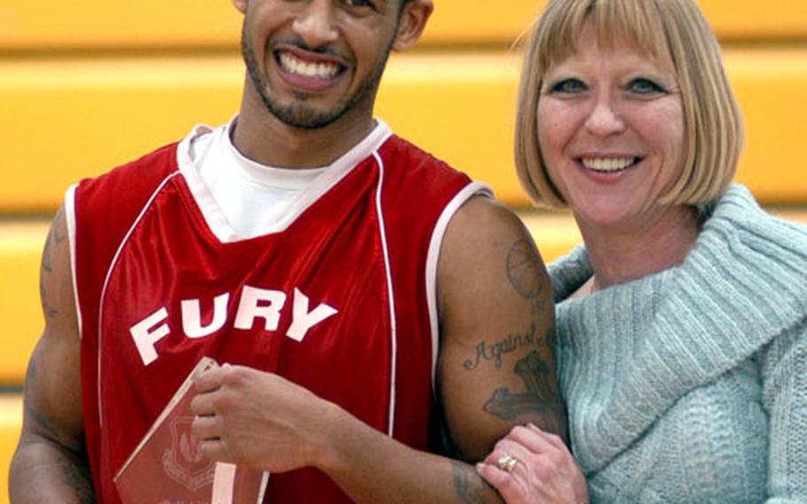 Lawrence Summers poses with Sharon Allen after receiving the MVP award. Sharon Allen is the wife of Dave Allen, a basketball official at RAF Lakenheath who died from cancer.